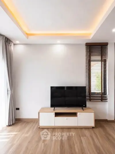Modern living room with wooden flooring and stylish TV stand