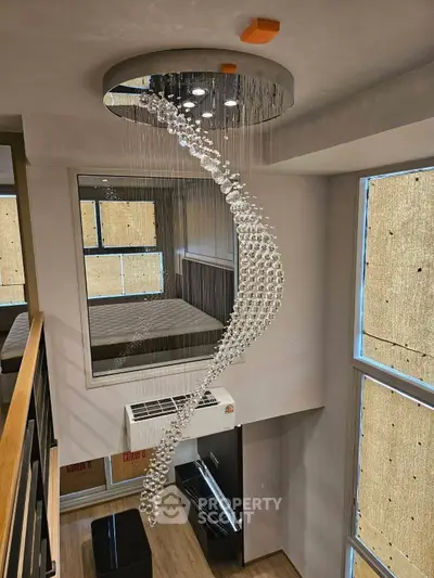 Luxurious modern interior with stunning spiral chandelier and large windows in a stylish loft apartment.