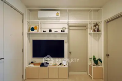 Modern living room with built-in shelving and flat-screen TV