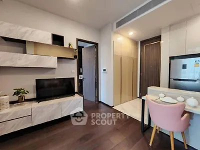 Modern apartment interior with integrated living space, featuring sleek kitchen appliances, a cozy dining area, and a stylish entertainment unit.