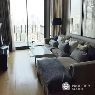 Luxurious high-rise living room with plush seating and floor-to-ceiling windows offering a panoramic city view, accentuated by natural light and modern decor.