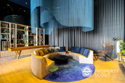 Chic modern living room with a unique curved sofa, vibrant blue rug, and elegant wooden accents, perfect for upscale urban living.