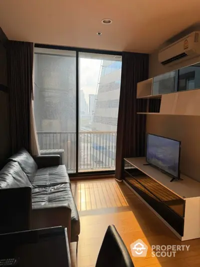 Modern living room with city view, sleek furniture, and natural light.