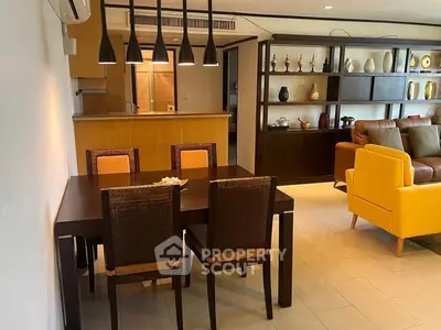 Stylish open-plan living room with modern dining area and cozy seating.