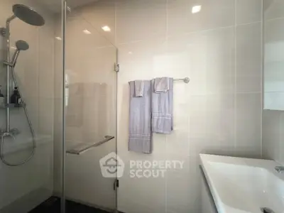 Modern bathroom with glass shower and sleek fixtures, perfect for a contemporary home.