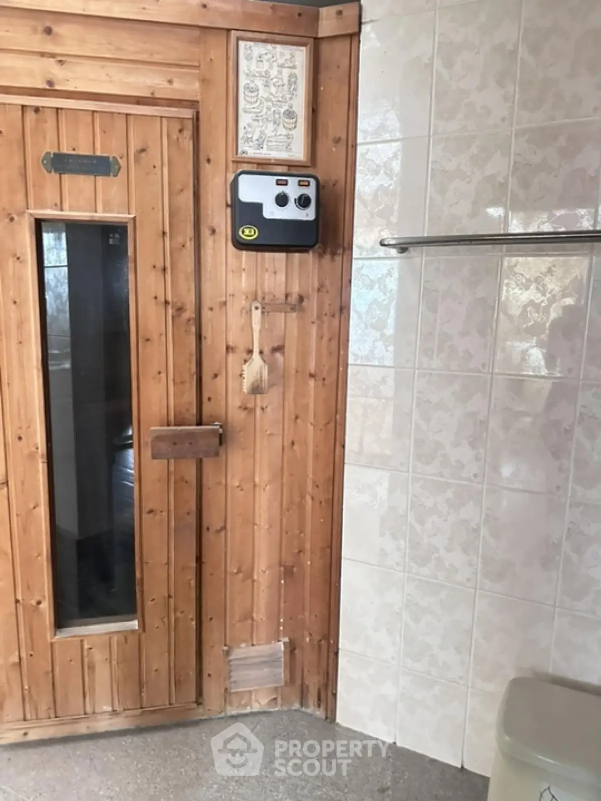 Charming wooden sauna room with tiled walls and modern amenities
