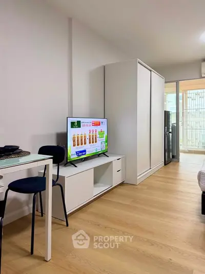 Modern studio apartment with sleek furniture and wooden flooring