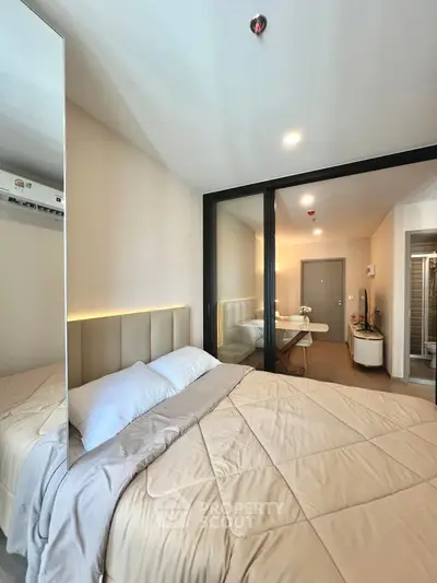 Modern bedroom with elegant decor and glass partition in stylish apartment