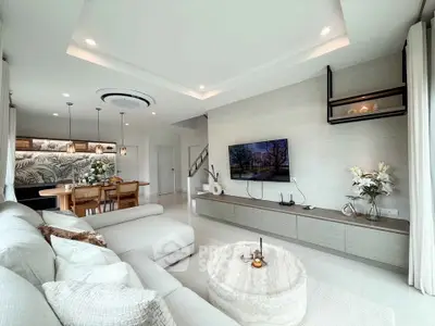 Spacious modern living room with elegant decor and open layout, perfect for family gatherings.