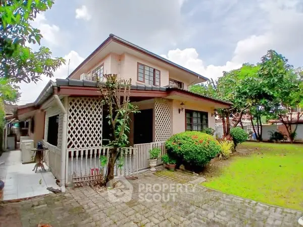 Charming two-story house with lush garden and spacious outdoor area, perfect for family living.