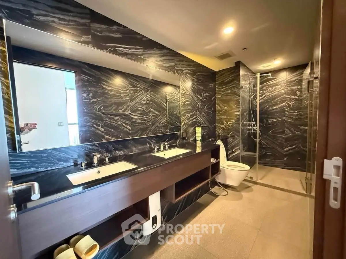 Luxurious modern bathroom with dual sinks and elegant marble walls