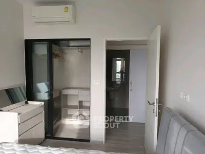 Modern bedroom with built-in closet and air conditioning in a stylish apartment.