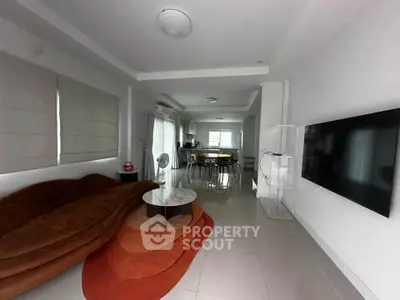 Spacious modern living room with sleek furniture and open layout, perfect for contemporary living.