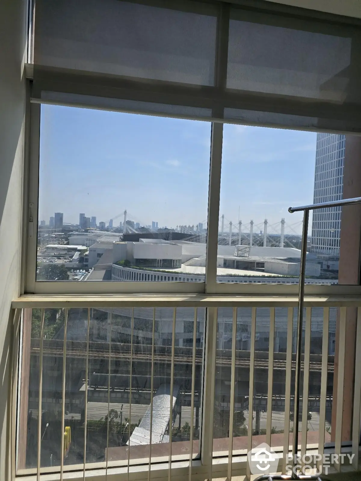 Stunning cityscape view from high-rise apartment window with modern skyline.