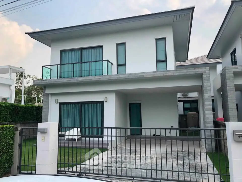 Modern two-story house with large windows and a spacious driveway in a suburban neighborhood.