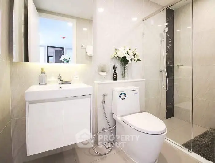 Modern bathroom with sleek fixtures and glass shower enclosure
