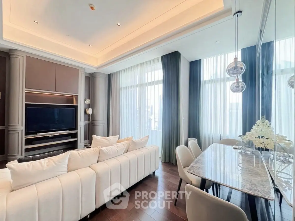 Luxurious living room with elegant dining area, high ceilings, and modern decor in a sophisticated apartment.