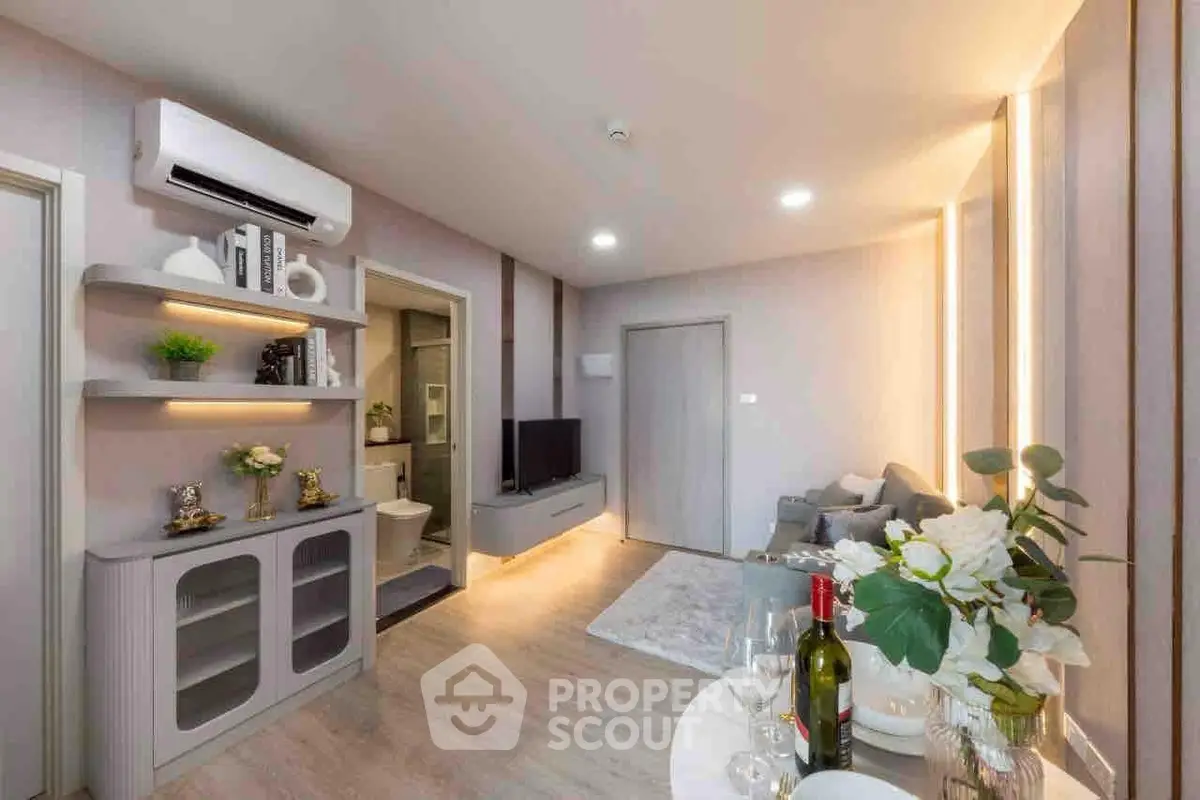 Modern living room with stylish decor, air conditioning, and cozy seating area.