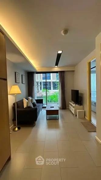Modern living room with cozy sofa and large window view in stylish apartment.