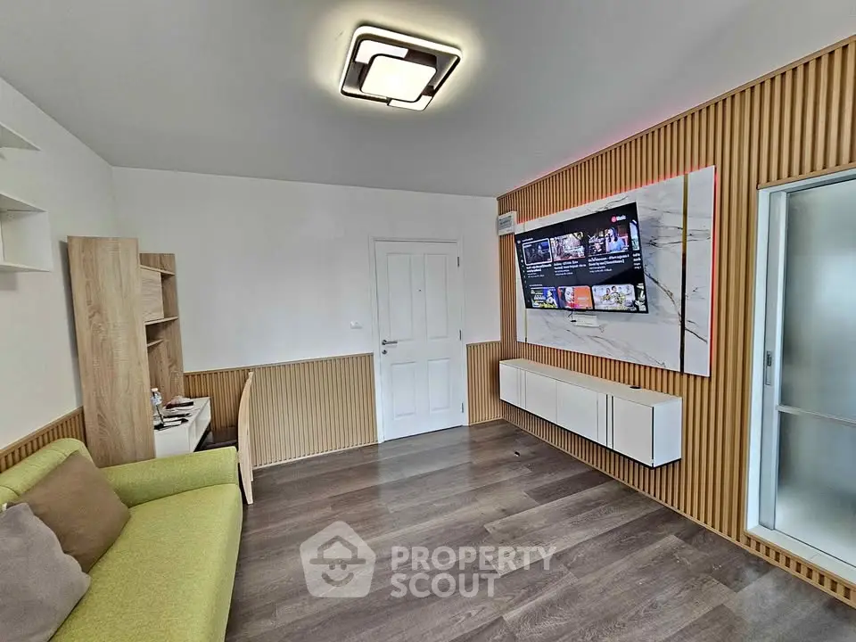 Modern living room with stylish wood paneling and wall-mounted TV