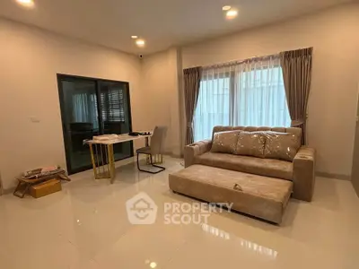 Spacious living room with modern furniture and large windows for natural light.