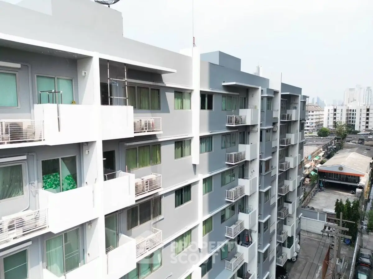 Modern urban apartment building with balconies and city view