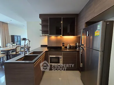 Modern kitchen with sleek cabinetry and stainless steel appliances in open layout