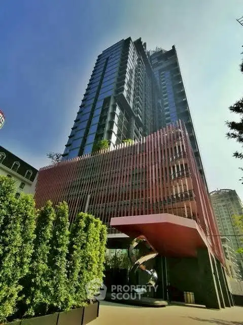 Stunning modern high-rise building with unique architectural design and lush greenery, perfect for urban living.