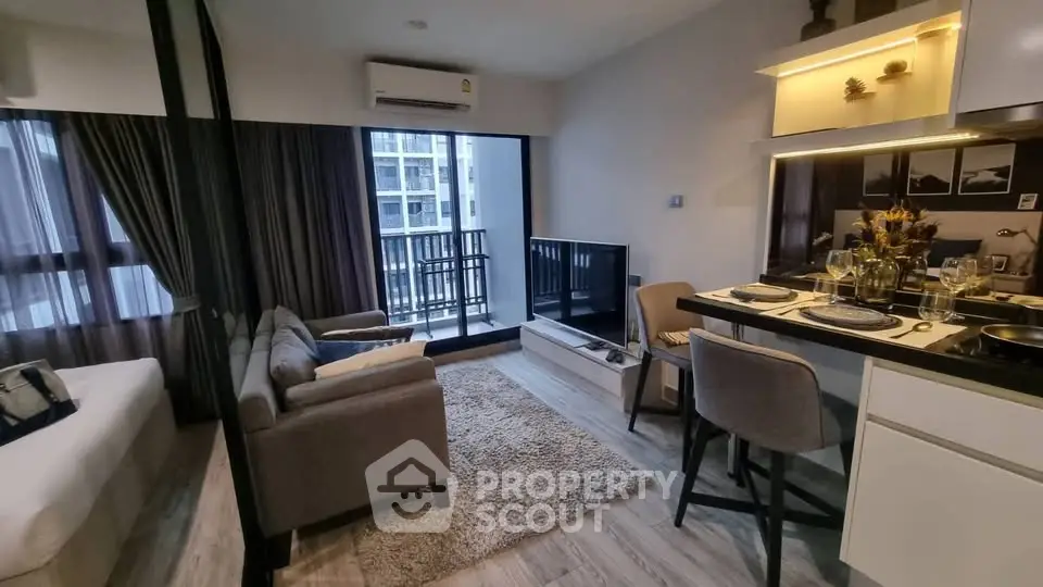 Modern studio apartment with open layout, cozy living area, and balcony view.