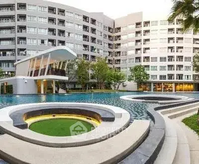 Luxurious apartment complex with modern pool and stylish architecture.