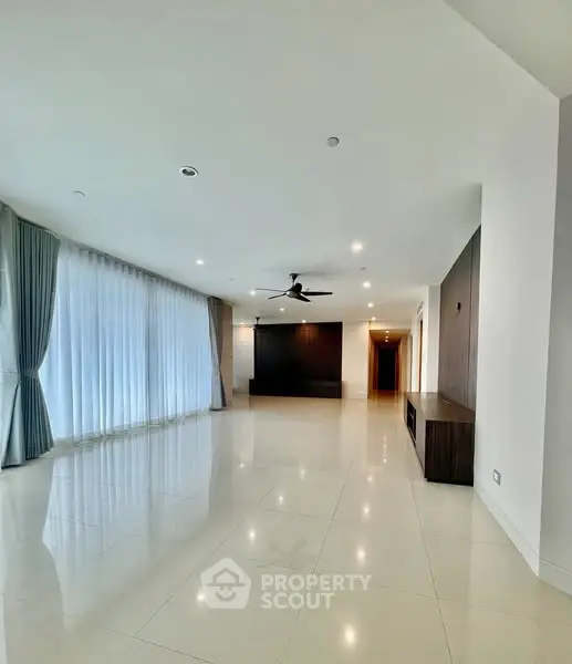Spacious modern living room with elegant curtains and ceiling fan