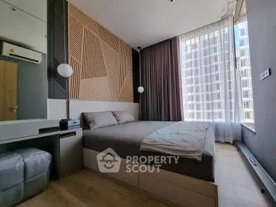 Modern bedroom with stylish decor and large window in urban apartment