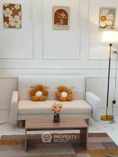 Charming living room with cozy white sofa and floral decor accents
