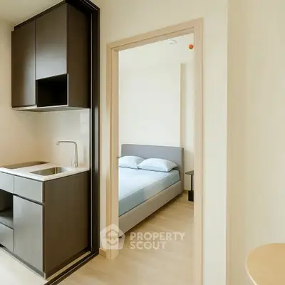 Modern studio apartment with compact kitchen and cozy bedroom