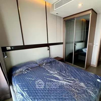 Modern bedroom with mirrored closet and stylish decor