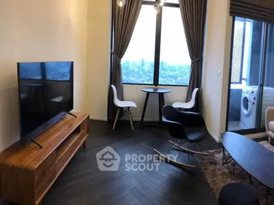 Modern living room with city view, stylish furniture, and adjacent laundry area.