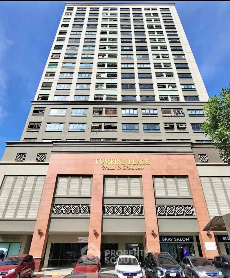 Modern high-rise building with retail spaces at Lumpini Place, showcasing urban living and convenience.