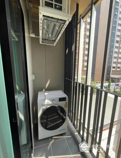 Modern balcony with washing machine and city view, ideal for urban living convenience.