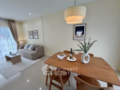 Modern living room with stylish dining area and cozy sofa, perfect for relaxation and entertaining.
