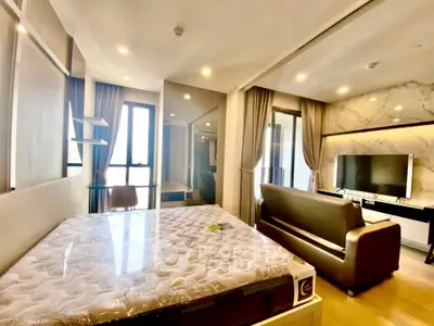 Modern studio apartment with stylish decor and large windows for natural light.