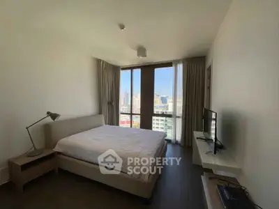 Modern bedroom with city view, featuring a cozy bed and sleek decor in a high-rise apartment.