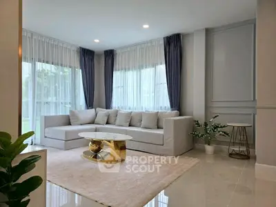 Elegant living room with modern sofa, chic coffee table, and large windows for natural light.