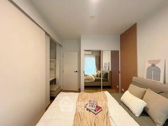 Modern bedroom with stylish decor and mirrored closet doors