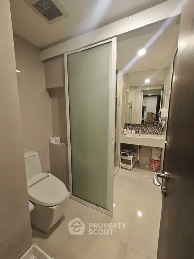 Modern bathroom with sleek design and frosted glass door