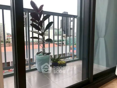 Charming balcony with city view and potted plants, perfect for relaxation.
