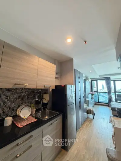 Modern kitchen with sleek cabinets and open layout in a stylish apartment