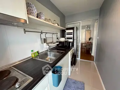 Modern kitchen with sleek countertops and appliances in a stylish apartment