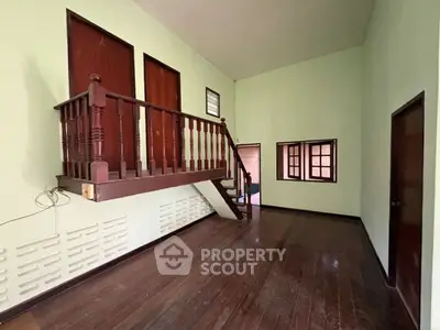 Spacious interior with wooden floors and unique loft area, perfect for creative living.