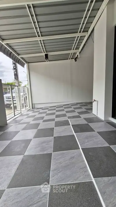 Spacious tiled balcony with modern design and ample natural light, perfect for relaxation.