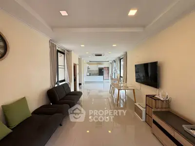 Spacious modern living room with sleek furniture and open layout, perfect for entertaining.